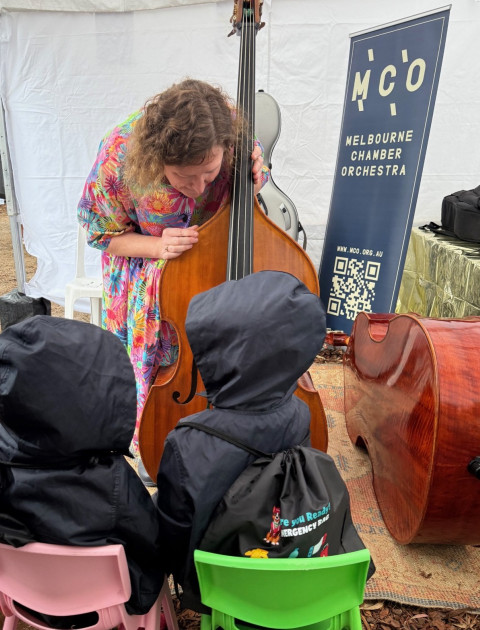 Musician playing double bass for children
