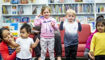 Some young children at a program in the library