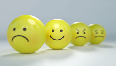four yellow balls with different facial expressions