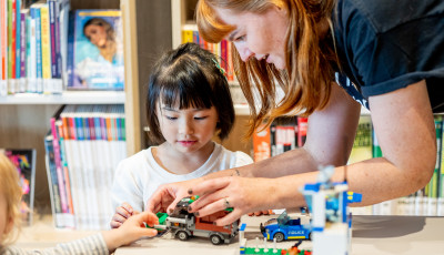 adult and child working on lego together