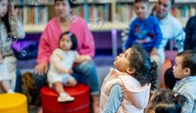 Small children with bubbles in the library