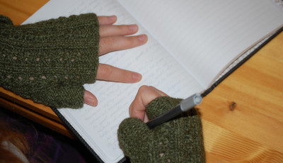hands in gloves with pen and paper