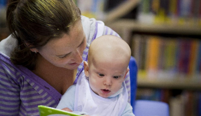 Mum and baby reading a book 