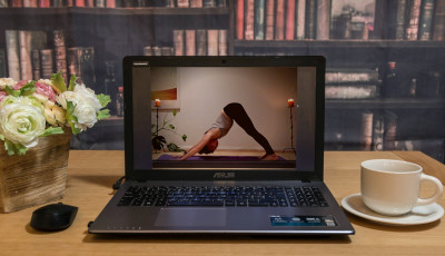 an image of a lady doing a yoga pose shown on a laptop