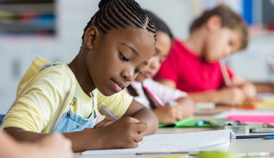 Girl writing in an exercise book.