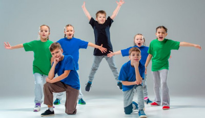 a group of children stand in different positions cheering