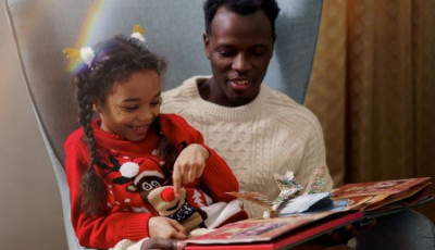 Father and daughter reading christmas book