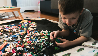 Child building and playing with lego