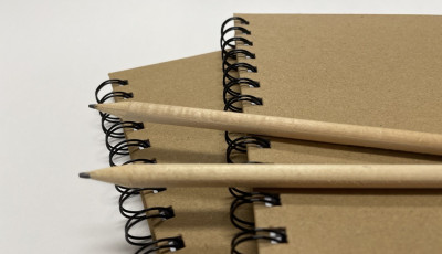 Two pencils on two journals