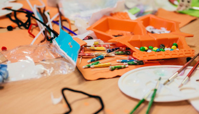 Colourful craft materials spread out on a table.