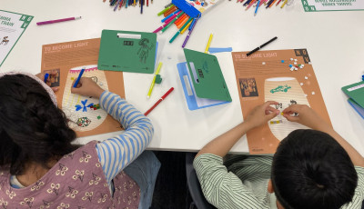 Overhead shot of two children drawing.