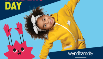 a kid in a yellow jumpsuit is smling and bending over