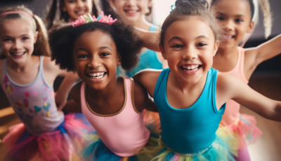 a group of girls in pink and blue leotards are smiling at the camera