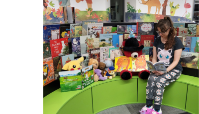 Staff member reading to teddy