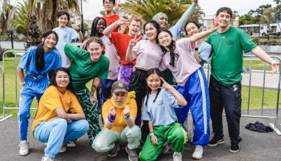 a group of teens are posed in a group and smiling at the camera