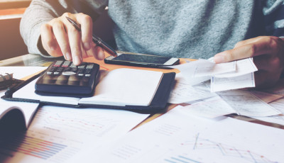 Business desk using calculator and notepad