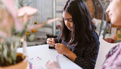 Child making a friendship bracelet