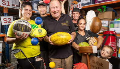 a group of people are holding up sport equipment and smiling at the camera
