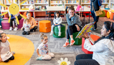 Woman reading story to children and adults