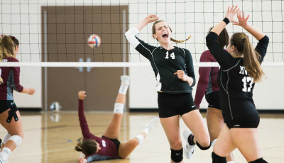 girls in black sports kit are playing volleyball