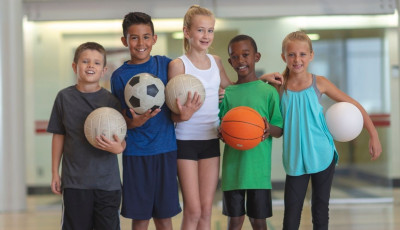 Kids holding sports balls