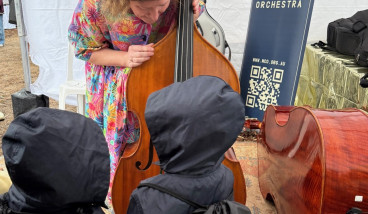 Musician playing double bass for children