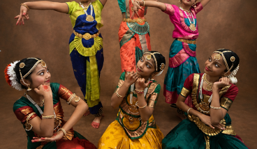 Indian classical Bharatanatyam dancers performing in vibrant traditional attire