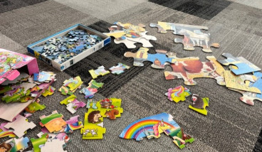 A range of jigsaw puzzles on the floor